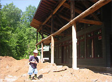 Photo of a child outside a house under construction