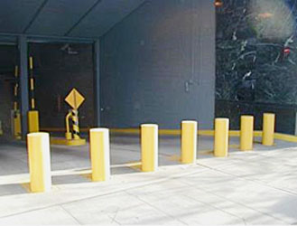 seven yellow bollards outside a security point