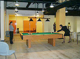 two women playing pool during a work break in the de-stress space of the GSA building in Denver