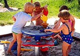 group of children playing at a sand table