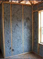 example of a wall with cellulose loose fill insulation installed between the wall joists