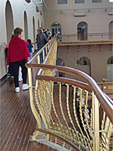 Compatible new painted metal railing inserted on the innerside of the historic railing