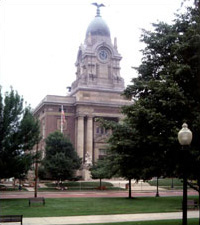 landmark building with pillars, a clock tower with a cupola and eagle on top