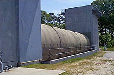 Photo of Navy's traditional out-of-airframe jet engine test cell lined with acoustical pillows and perforated stainless  steel inner panels