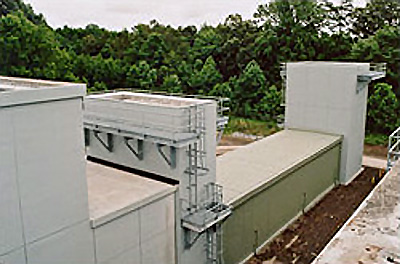 Photo of precast lightweight concrete for the outer square shell of the augmenter lined with acoustical pillows and perforated stainless steel inner panels