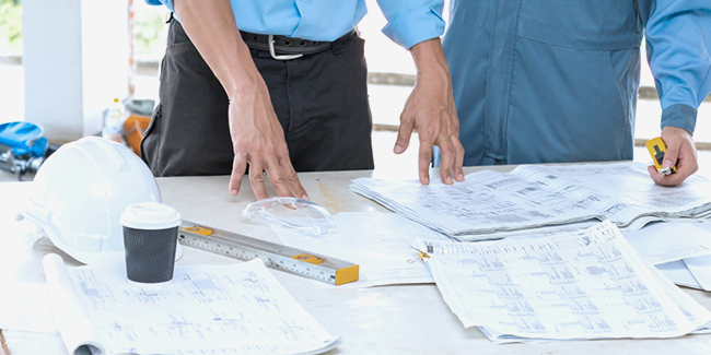 stock photo of workers looking at papers on a table