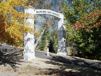 Entry to of Rancho San Rafael in Reno, Nevada with a single white bollard in the center of the roadway