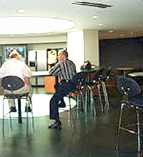 two men sitting in the circular skylit cafe off the entryway of the GSA office building in Denver