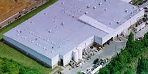 Aerial view of low slope cool metal roof covering a lot of sq footage on an industrial building