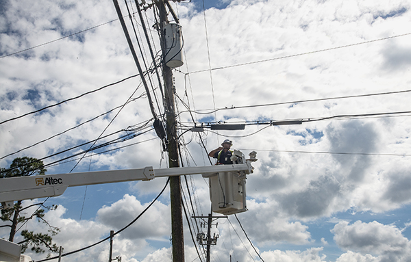 utilities crews working to restore power in Metairie, LA after Hurricane Ida