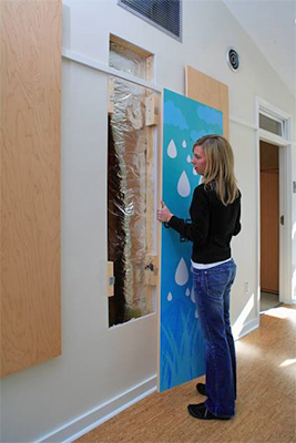 Woman hanging a picture in the Home Depot Smart Home