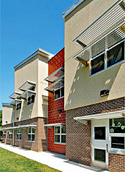 Exterior of Glebe Elementary School with horizontal window shades as part of passive solar design