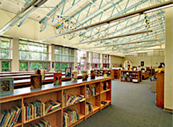 Library-media room at elementary school with high ceilings featuring skylights providing ample daylight