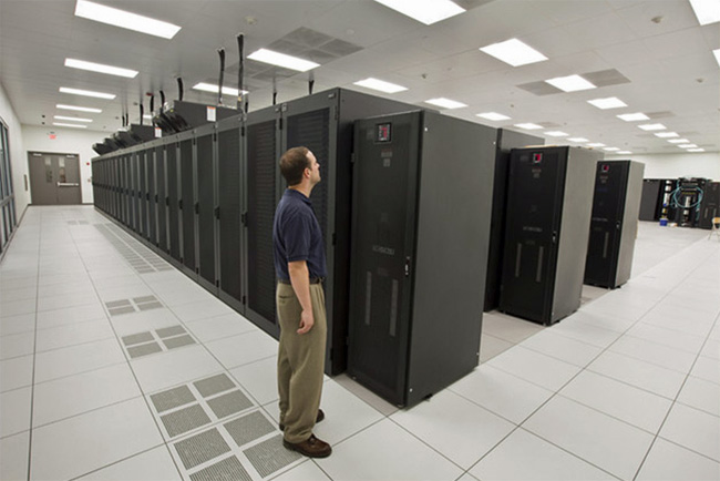 Man standing in server room at Emerson Data Center