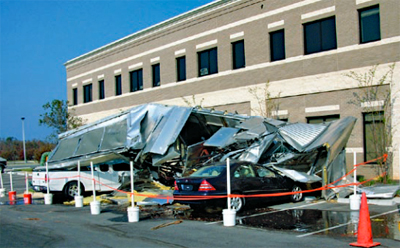 Photo of an 18,000 pound HVAC unit that blew off a roof and landed in a parking lot