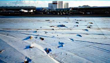 Photo of a fully adhered single-ply membrane struck by a large number of missiles during a hurricane