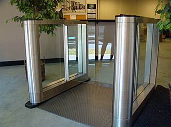 Free-standing, half-height turnstile installation utilizing a drop in floor mounting panel.