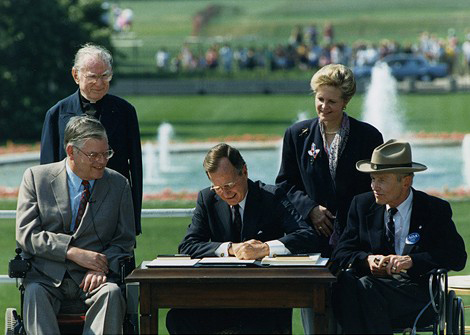 President George H.W. Bush signs the ADA into law 1990