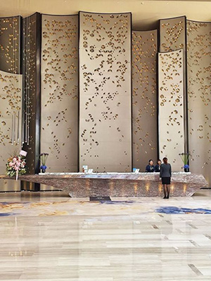 lobby featuring large-scale artwork, high-end materials and finishes, taking advantage of the large volume of the space