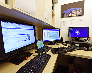 Computer monitors showing how a building and its systems can be managed