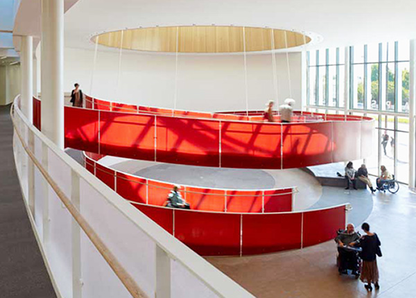Ed Roberts Campus in Berkeley, CA, featuring a spiraling ramp with bright red walls