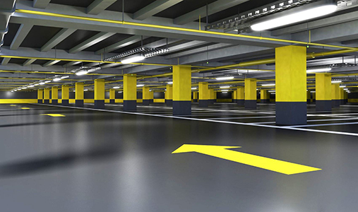Basement parking garage with brightly painted directional arrows and columns