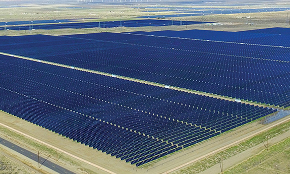 Aerial photo of multiple rows of thin-film solar panels in a field in Nevada