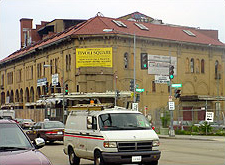 Photo of a street with traffic, stoplights, and construction