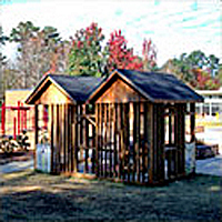 A pair of Custom-designed adjoining wooden playhouses on a playground