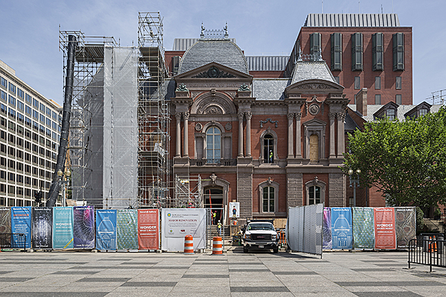 Exterior of the Renwick Gallery, Smithsonian American Art Museum with scaffolding and protective screening installed during construction.