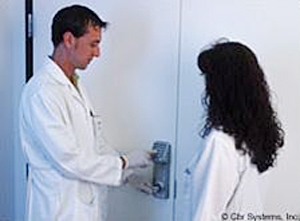 laboratory technicians using a swipe reader to enter restricted area
