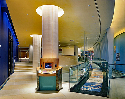 Interior of the Children's Hospital at Montefiore with stairs on the left, huge white columns through the center and a colorful wheelchair ramp along the right