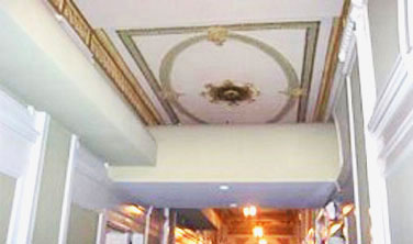 highly ornamented ceiling trim with utility soffits and ducts installed over it which do not meet the Sectretary's standards