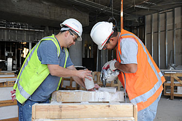 construction workers cutting stone