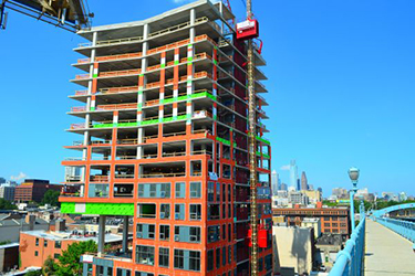 VaproShield WrapShield SA, shown in orange, installed on the Bridge apartment building during construction