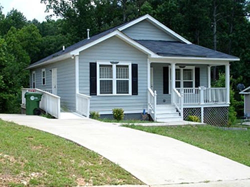 Habitat for Humanity house with an accessabilty ramp on the left side of the house off of the driveway