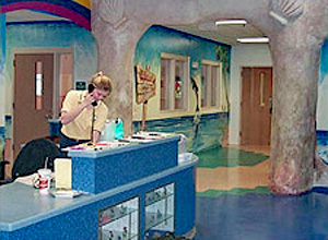 Worker answering the phone behind the main desk at the youth center, naval station Mayport